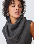 Woman wearing a gray scarf against a white background