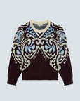 A long-sleeve crewneck sweater featuring a dark brown base with a large, symmetrical ikat-style pattern in cream and light blue across the chest and shoulders, displayed on a light gray background.