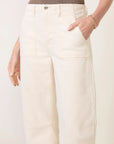 model wearing a bone colored utility jean / pant with a brown tank on a white background