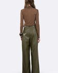 A model shown from the back wearing a brown long-sleeve top and olive green wide-leg trousers against a light gray studio background.