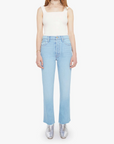 Woman wearing a white sleeveless top and light blue jeans on a white background front view