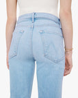 Light blue jeans worn by a person on a white background