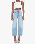 Woman wearing light blue jeans and a white top on a white background, front