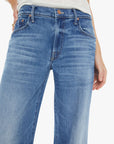 Blue jeans worn by a person on a white background