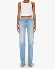 Woman wearing light blue jeans and a white top on a white background
