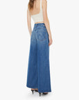 Woman wearing a long blue denim skirt on a white background