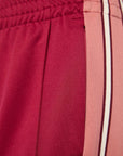 close up on track pants with stripes on the side
