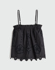 Black lace top with thin straps on a light gray background