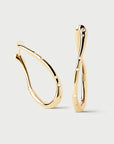 Gold hoop earrings on a light gray background