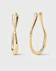 Gold hoop earrings on a light gray background