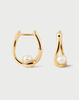 Gold hoop earrings with pearls on a light gray background