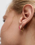 Close-up of an ear wearing Rhodochrosite Luna Earrings