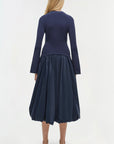 Navy blue dress with long sleeves and a full skirt on a white background back