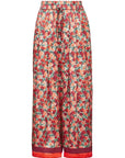 A pair of high-waisted, wide-leg cropped pants featuring an all-over red and orange floral print with green leaves, finished with a solid red drawstring waist and a matching red hem.