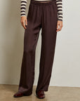 Person wearing brown wide-leg pants and a striped shirt against a plain background front view