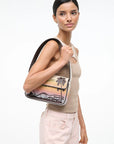 Woman holding a shoulder bag with a scenic design on a white background