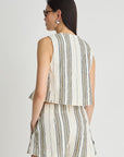 Woman wearing a sleeveless striped top and shorts set on a white background