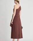 model wearing a one shoulder brown dress with a white background