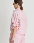 Woman wearing a pink outfit on a white background