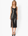 Woman wearing a black leather dress on a white background
