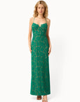 Woman wearing a green floral dress on a white background