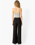 Amani Rib Knit Bodysuit with black pants, full body back