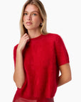 Woman wearing a red sweater on a white background