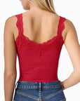 Red lace-trimmed tank top worn by a person on a white background