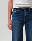 Person wearing blue jeans with a white background