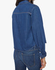 Woman wearing a blue denim jacket and jeans on a white background