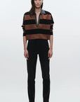 Person wearing a black and brown striped shirt with a white background, full body