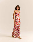 Woman wearing a floral dress on a beige background