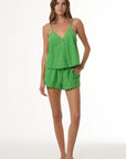 Woman wearing a green outfit on a white background