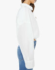 Woman wearing a white shirt with a high collar on a white background