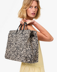 Clare V Summer Simple Tote Black/Cream Raffia held behind shoulder