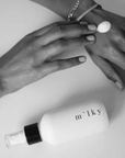 Riddle 4 oz Milky Spray Lotion Poppy, lotion on hand