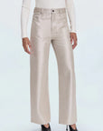 Beige wide-leg pants worn with a white top on a white background