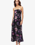 Woman wearing a strapless floral dress on a white background