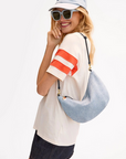 Clare V Lune Denim Suede Bag on shoulder, side view