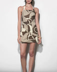 Woman wearing a patterned dress against a white background