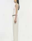 Person wearing a white sleeveless top and pants on a white background