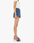 Woman wearing a white top and blue denim skirt on a white background