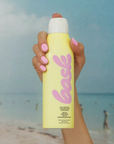 Bask SPF 50 Non-Aerosol Spray Sunscreen held
