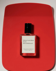 Perfume Oil No.04 Bois De Balincourt .5oz on red mat
