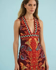 model wearing a print vneck sleeveless dress on a blue background