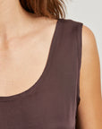 Brown tank top worn by a person on a light gray background close up view