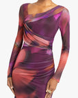 Long-sleeve dress with abstract multicolor pattern on a white background up close view