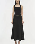 Woman wearing a black sleeveless dress on a white background