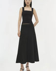 Woman wearing a black dress on a white background