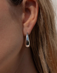 Thatch Lumi Hoop Earring Rhodium on ear